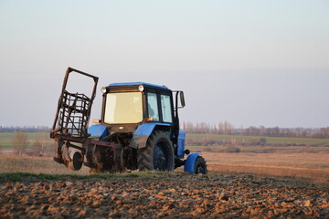 tractor which cultivates the field in autumn