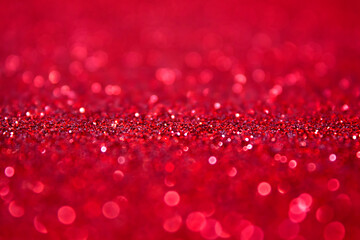 Christmas xmas or New Year Eve background. red abstract background with selective focus in the middle. St. valentine day, Red glitter bokeh vintage lights, Happy holiday new year, defocused.