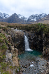 Fototapeta na wymiar beautiful waterfalls Fairy Pools under the snowy mountains