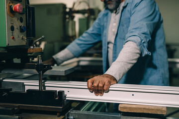 Aluminium and PVC industry worker making PVC or aluminium frames for windows and doors