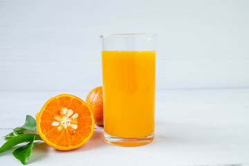 Fresh orange and orange juice on the table