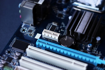 Fototapeta na wymiar Computer motherboard closeup in tilt shift style. Computer equipment repair, assembly and upgrade of system units. Selective focus, defocused