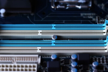 Computer motherboard closeup in tilt shift style. Empty four slots for RAM memory stick. Selective...