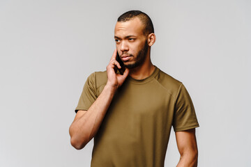 Portrait of a young african american man holding mobile cell phone