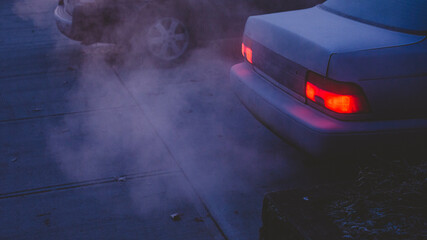 Car exhaust in early, frosty morning