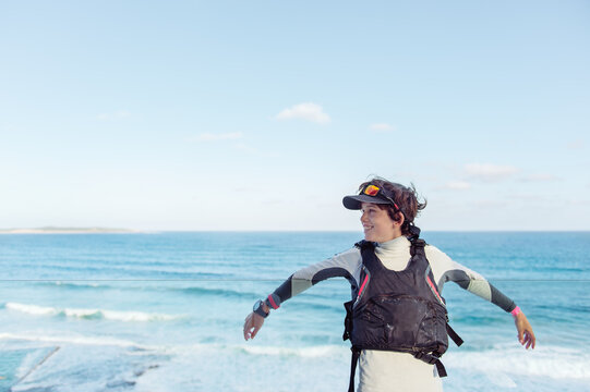 Child in sailing gear on a balcony beside the ocean