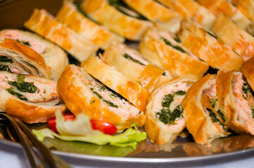 Fish strudel with spinach sliced ​​in a bowl.