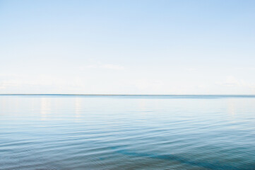 Seascape with calm water and clear sky on a summer evening
