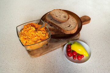 Spread from grated carrot, parsley and celery with plant mayonnaise, bread and tomato.
