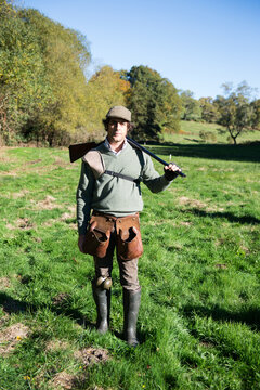 Hunter walking with his shotgun open