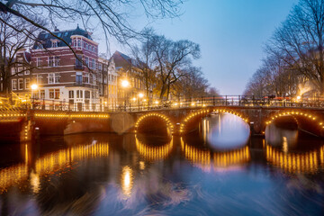 Beautiful bridges in the center of Amsterdam by night during winter , Netherlands