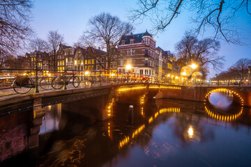 Beautiful bridges in the center of Amsterdam by night during winter , Netherlands