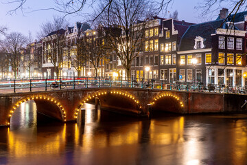 Fototapeta na wymiar Beautiful bridges in the center of Amsterdam by night during winter , Netherlands