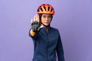 Teenager cyclist girl making stop gesture - obrazy, fototapety, plakaty