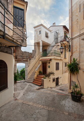 Fototapeta na wymiar Italian picturesque alleys in San Felice Circeo old town village. Typical old houses reflecting the local architecture..
