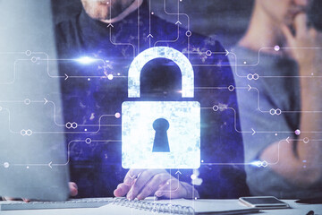 Multi exposure of lock icon with man working on computer on background. Concept of network protection.