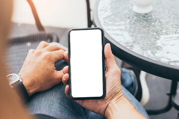 cell phone mockup blank white screen.man hand holding texting using mobile on desk at coffee shop.background empty space for advertise.work people contact marketing business,technology
