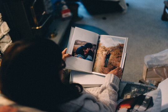 A woman flipping through a photo album