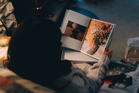 A woman flipping through a photo album