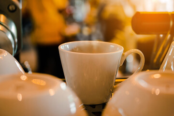 Vintage hot coffee cup on blurred coffee shop background