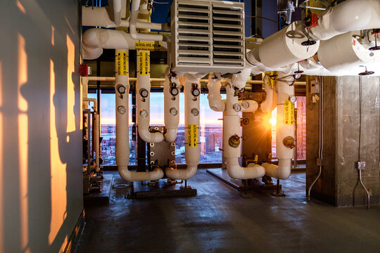 Sunrise pours into a building mechanical room in a building.