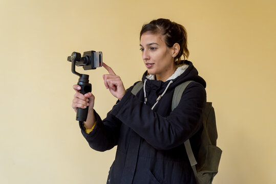Woman holds mobile phone on gimbal