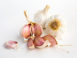 garlic heads and cloves on white background