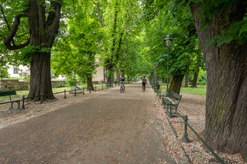 Biker and pedestrian in Planty Park in Cracow during springtime 2020