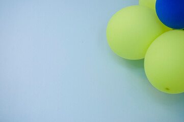 A blue background with balloons in the corner
