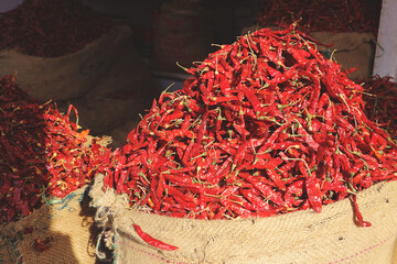 Dried red chili peppers in big bags. Indian chilli at the bazaar.