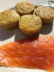Vegetable cutlets with broccoli and trout in a white plate