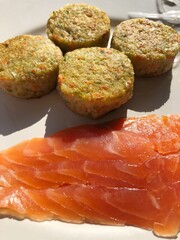 Vegetable cutlets with broccoli and trout in a white plate