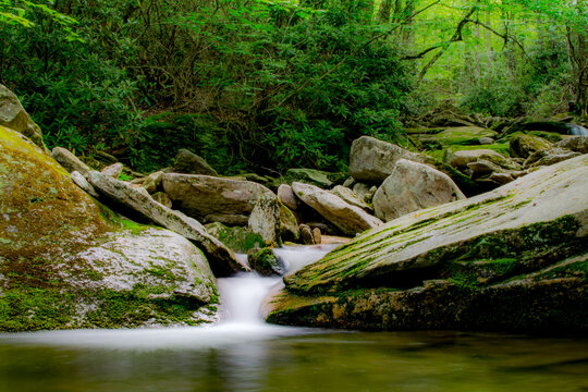 Small waterfall on creek in the Appalachian forest, secret swimming / fishing hole, mossy rocks, North Carolina woods