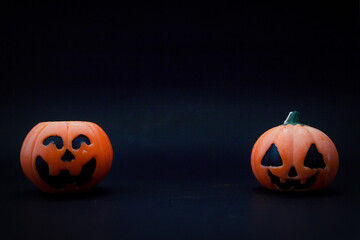 Halloween pumpkins on the black paper background. Halloween background. Space for text. copy space.