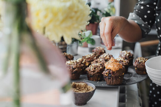 Woman Decorating Salty Muffins
