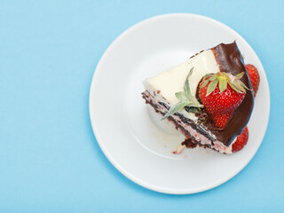 Piece of homemade chocolate cake decorated with fresh strawberries