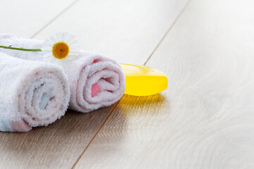 White towels and soap for bathroom procedures with chamomile flower