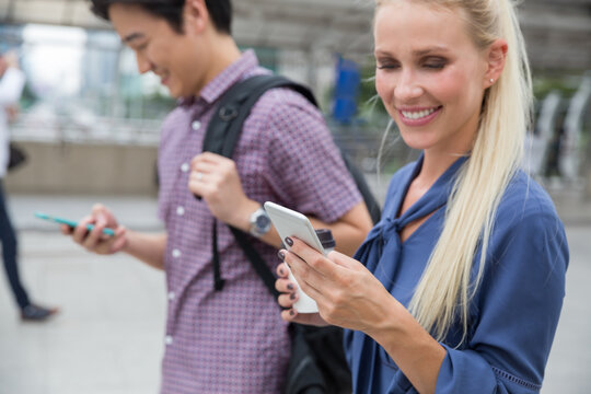 Group of young coworkers walking around the city together