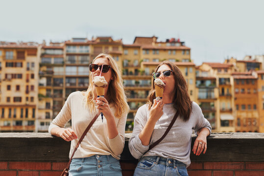 Beautiful girl friends eating ice cream delicious italian gelato