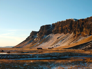 A lonely house at the foot of the mountains in Iceland. Incredible landscapes of nature. Life for a social phobia