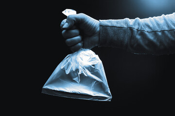 Human hand holding a plastic bag filled with clean air. Coronavirus, ventilation and protection concept.