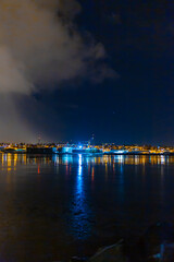 Night photo of Reykjavik city beach. Waterfront lights