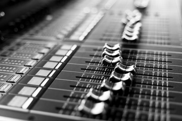 Professional audio mixing console with faders and adjusting knobs, TV equipment Black and White...