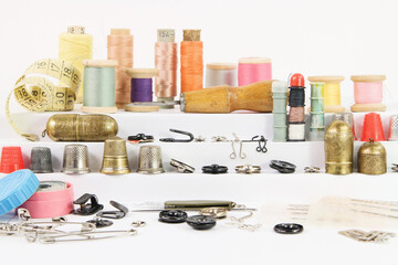 Various vintage accessories and tools for sewing on white stairs