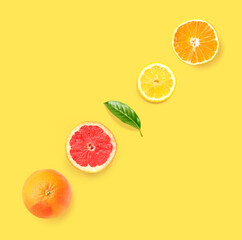 Creative layout made of grapefruit, orange and lemon on the yellow background. Flat lay. Food concept.