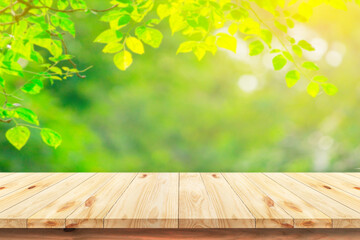 Wood floor with blurred trees of nature park background and summer season, product display montage