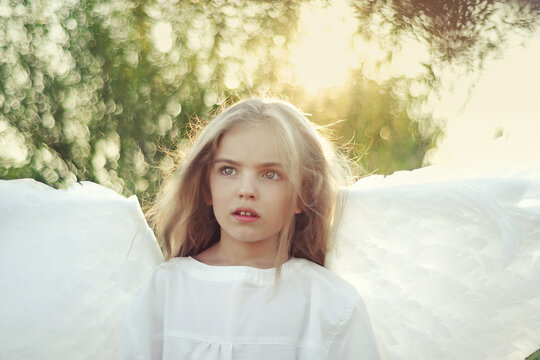 Child girl angel on nature. Beautiful look