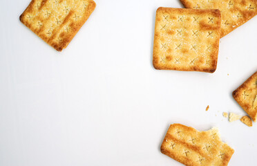 Square crackers or biscuits and cracked biscuits on the white background 