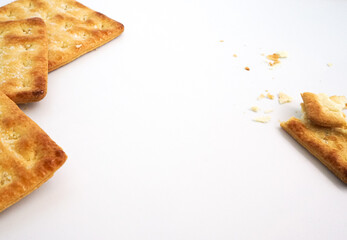 Square crackers or biscuits and cracked biscuits on the white background 