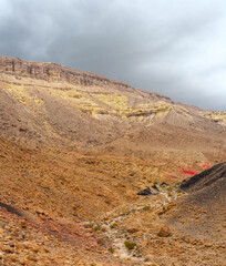 Deserted rocky slope of the canyon with multi-colored stones.